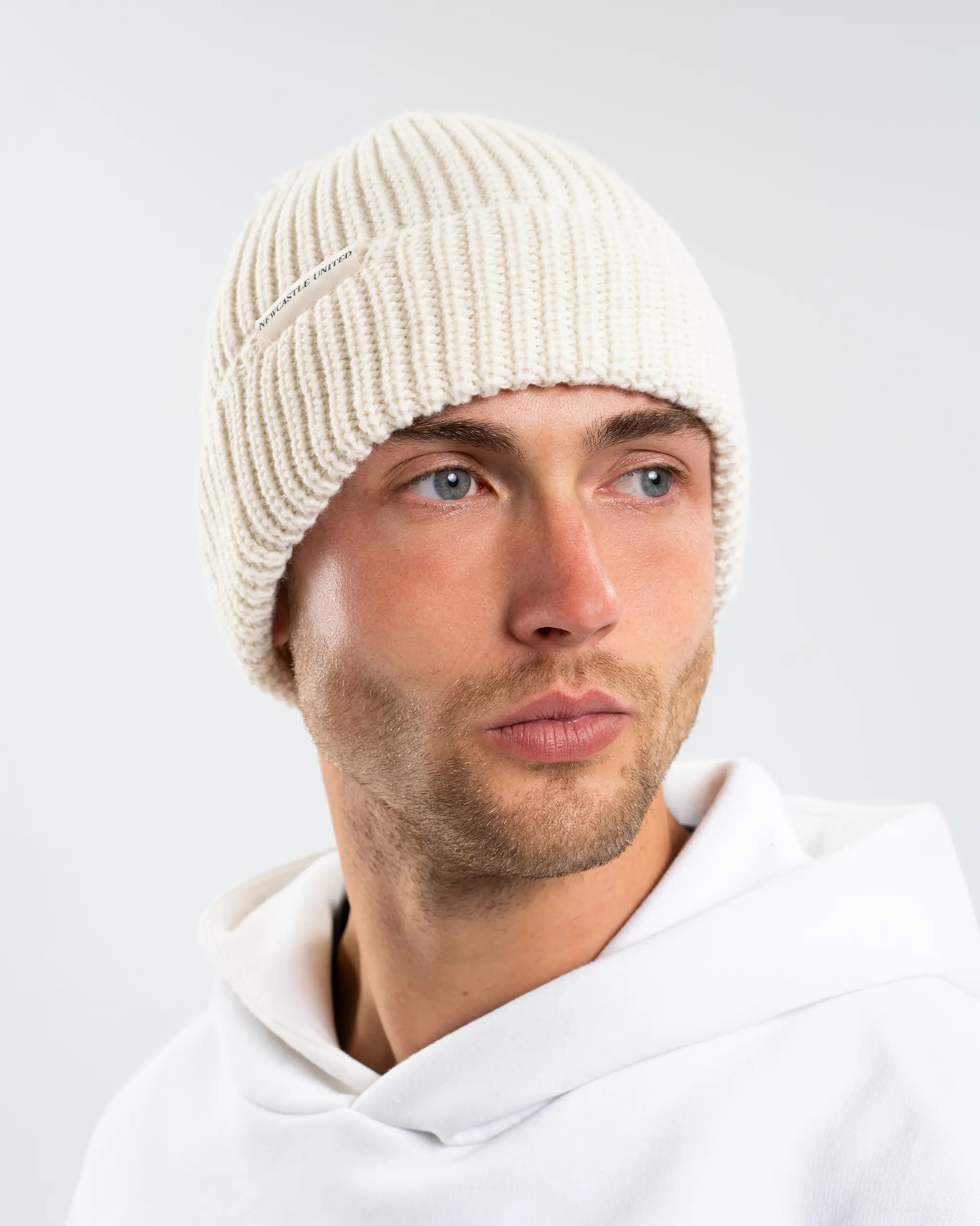 Newcastle United New Era Beige Woven Label Beanie - Image 4